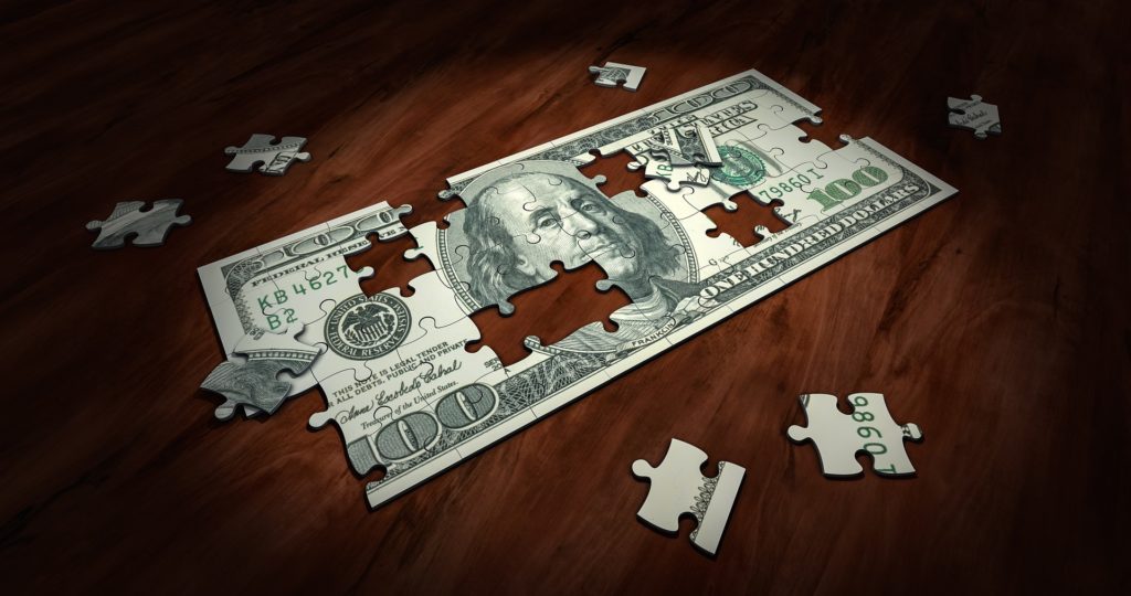 100 dollar bill formed from puzzle pieces